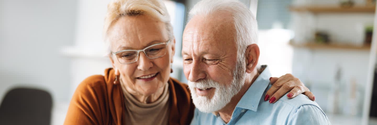 Elderly couple looking at computer