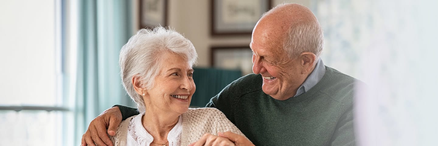 Senior couple smiling at one another