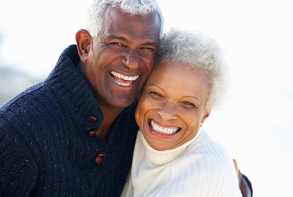 A senior couple embracing and smiling