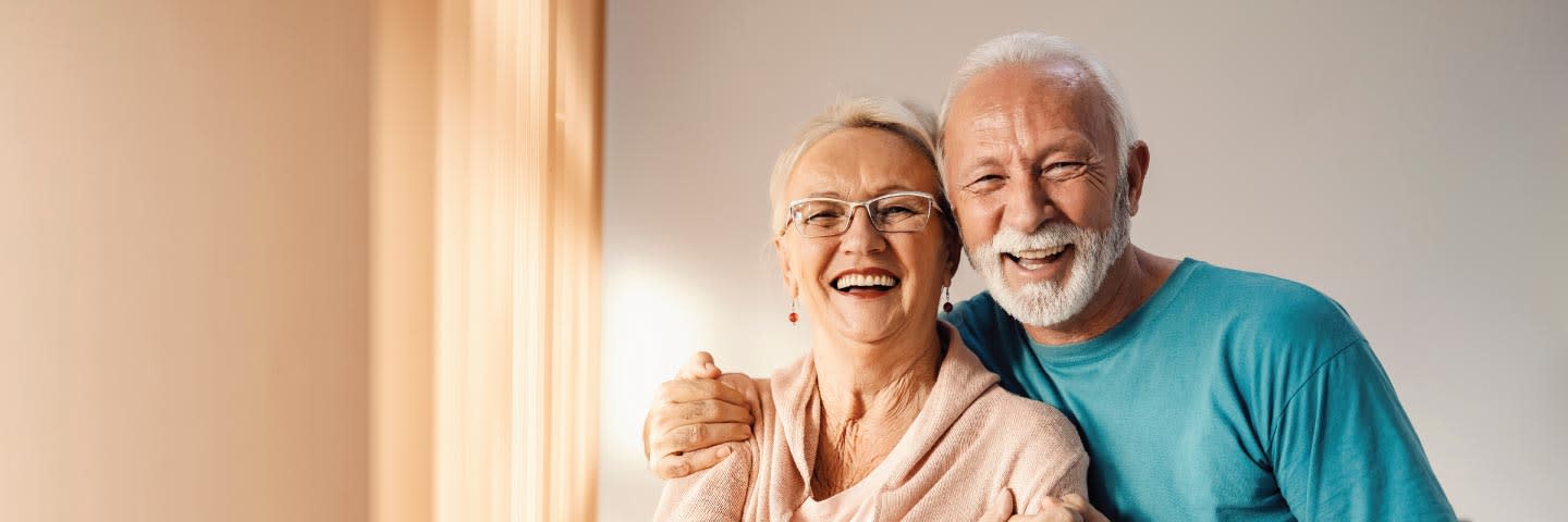Elderly couple posing and smiling