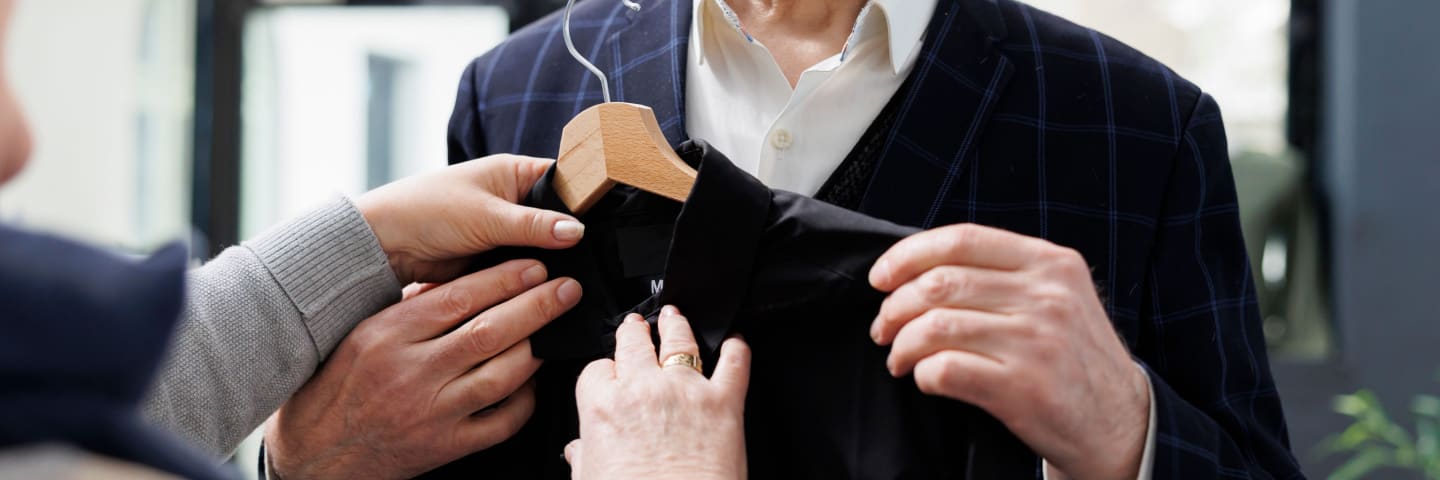 Man selecting adaptive clothing for seniors.