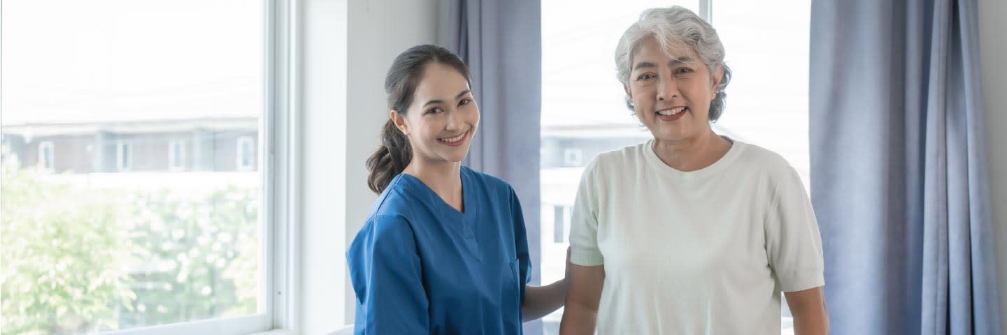 Elderly woman and caregiver