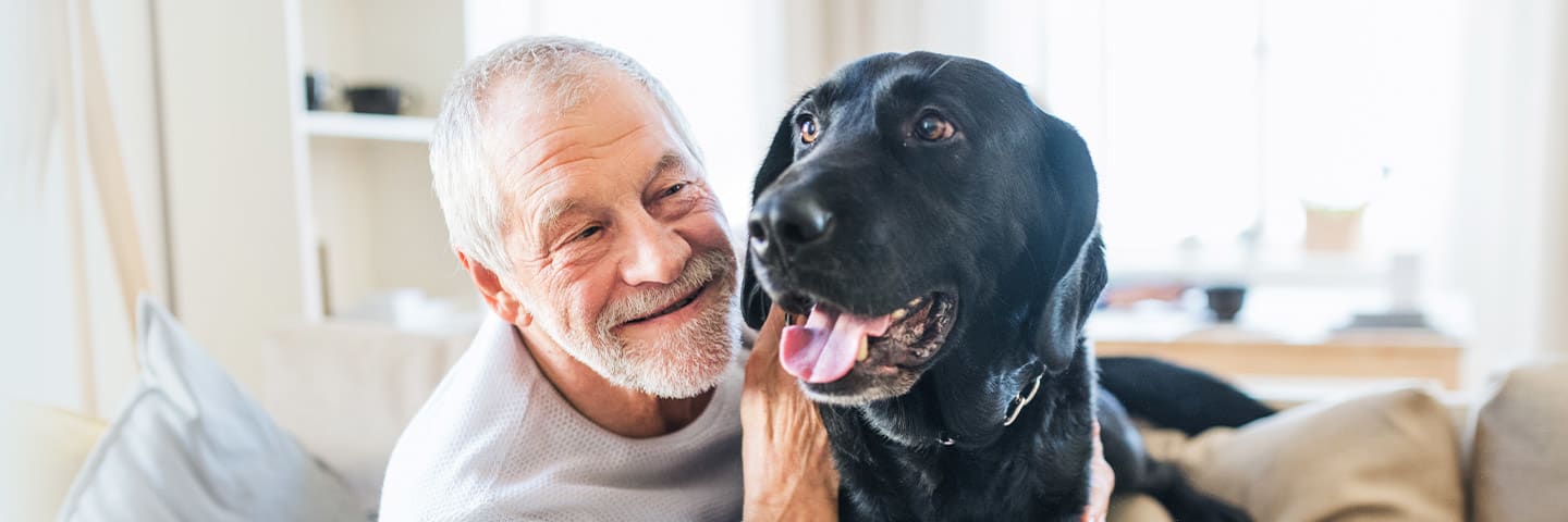 Senior embracing a cute dog