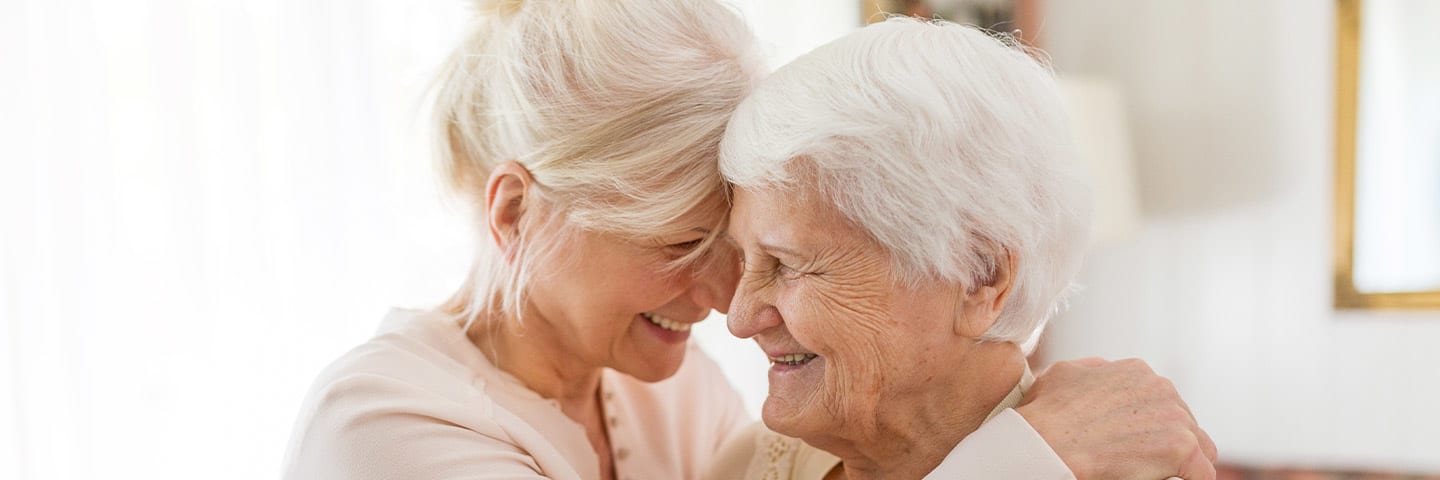 Daughter and senior mother hugging each other lovingly