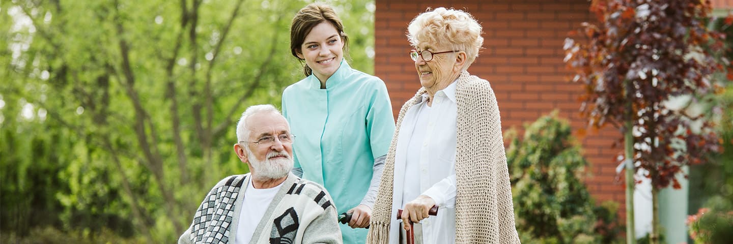 Seniors outside with caregiver