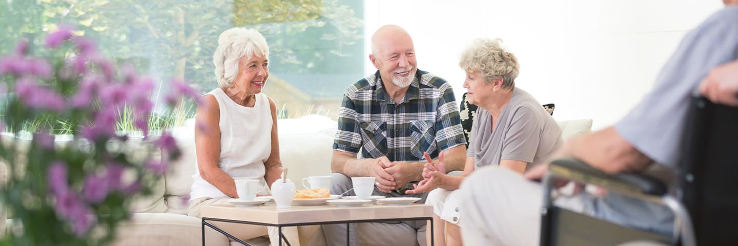 Group of seniors chating in an common area at an assisted living facility