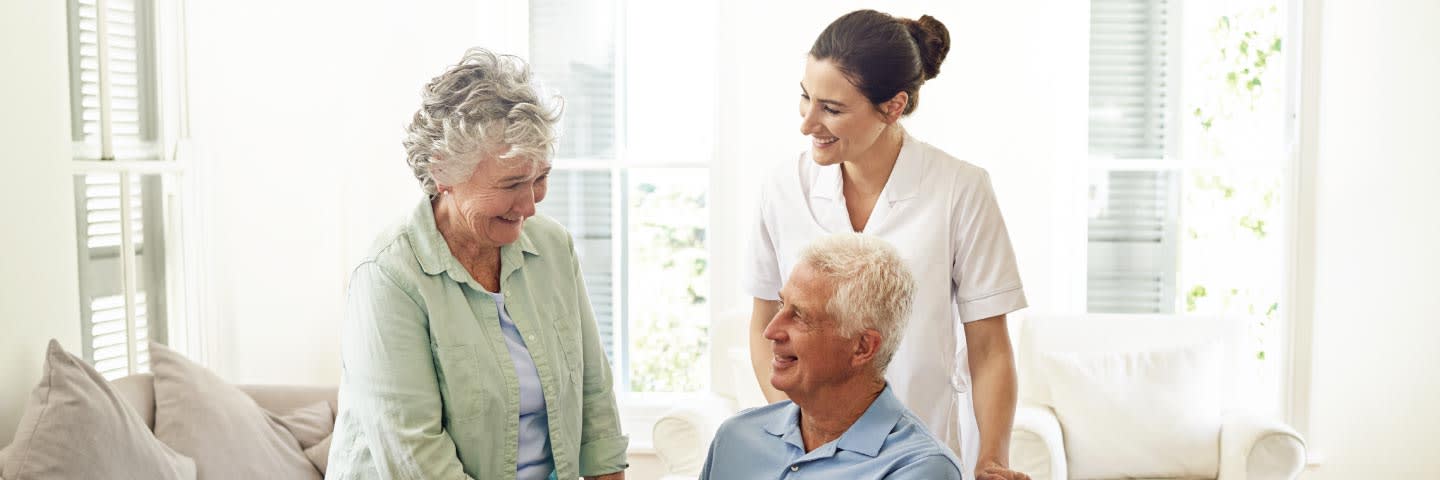 Elderly man with wife and his caregiver