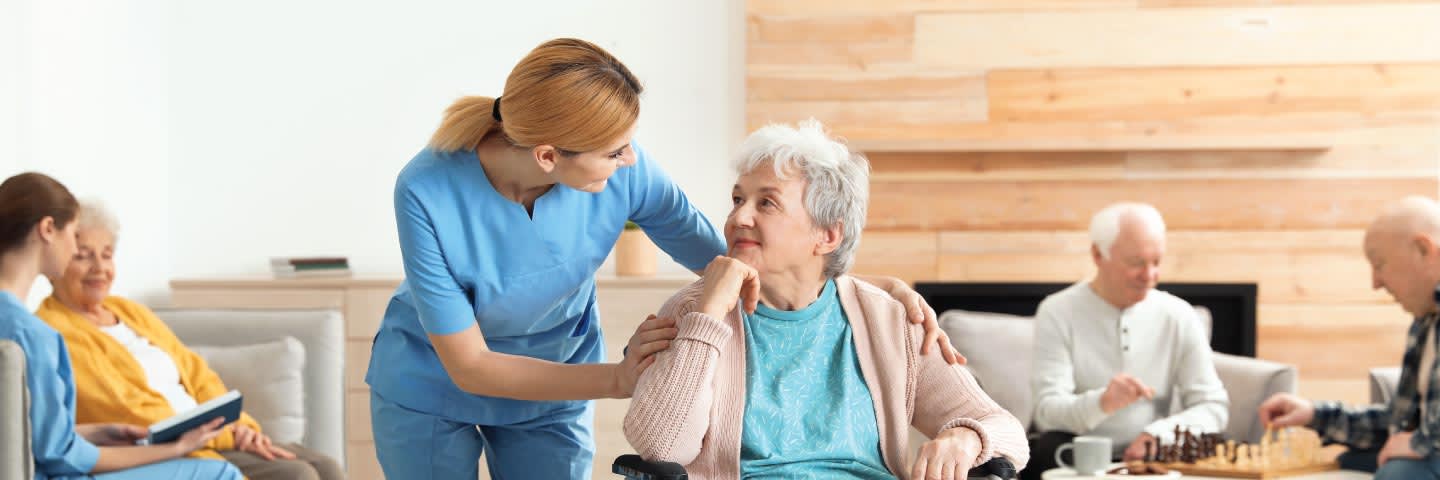 Nurse talking to elderly woman at nursing home
