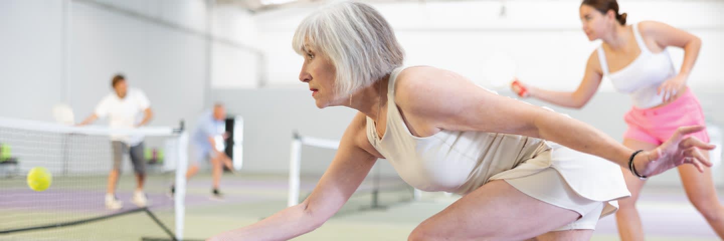 Elderly woman playing pickleball