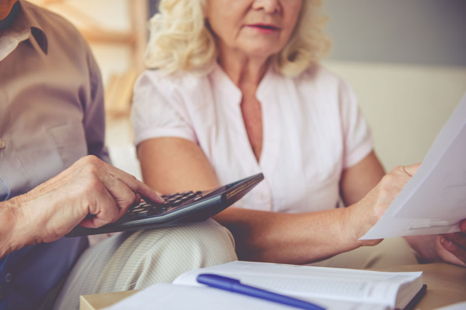 A senior couple reviewing care costs