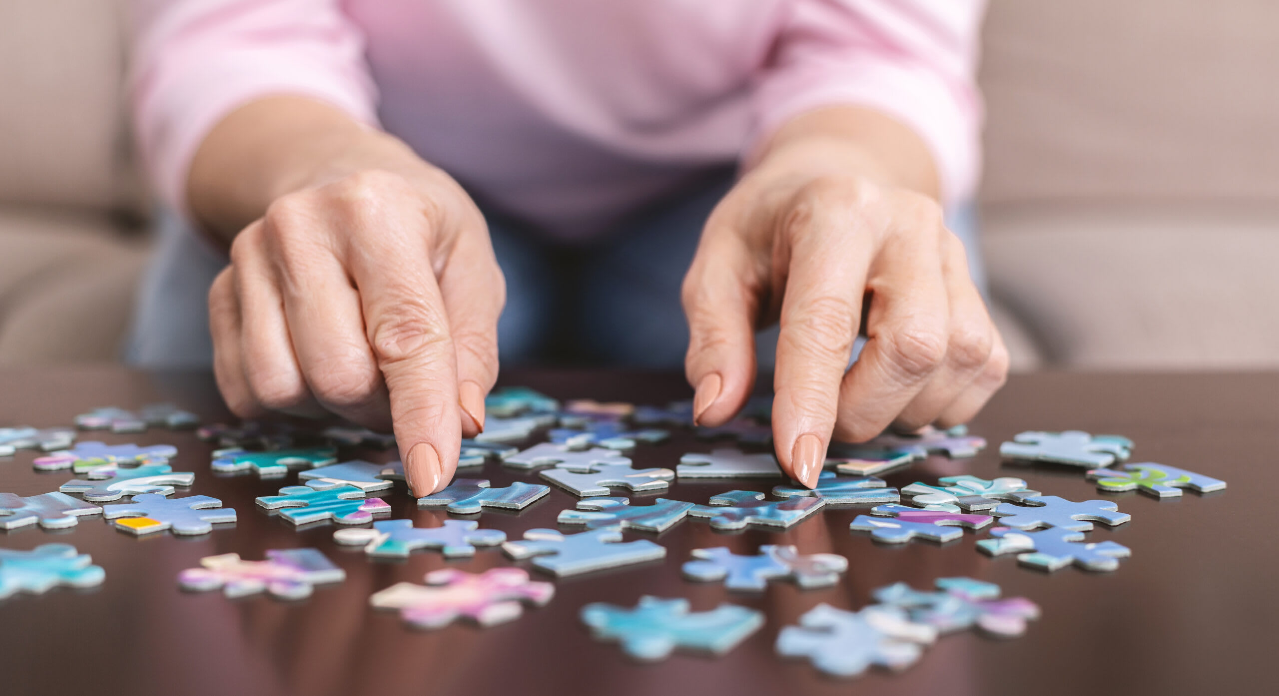 Person solving a jigsaw puzzle