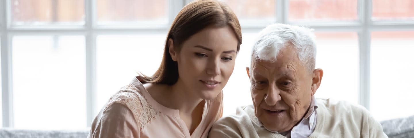 An elderly father with his adult daughter