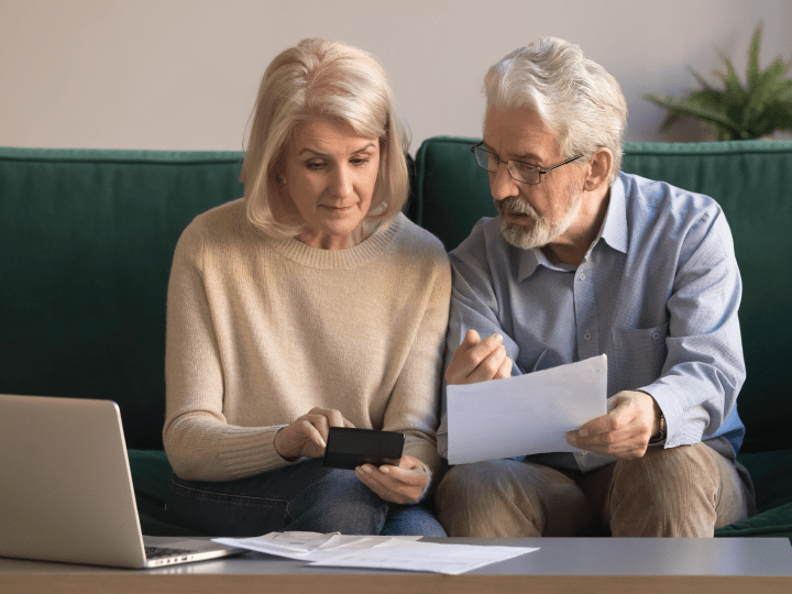 Elderly couple discussing documents