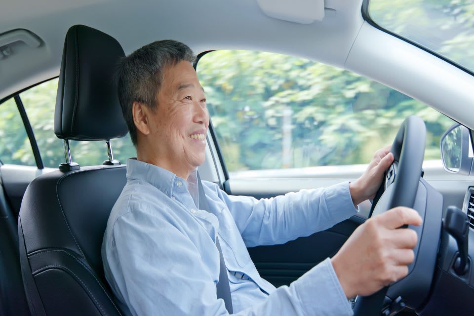 Elderly man driving.