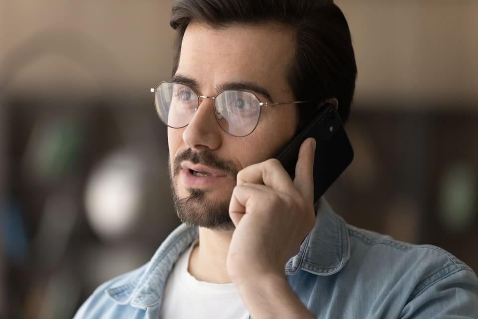 Bearded man on phone with dementia hotline.