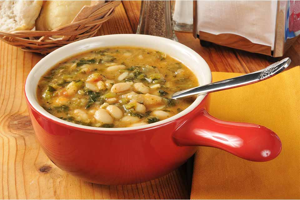 Soup in a red bowl with a spoon