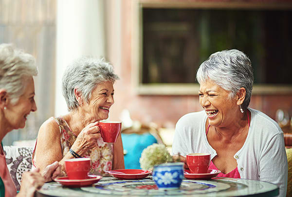 A group of senior women socializing at a cafe