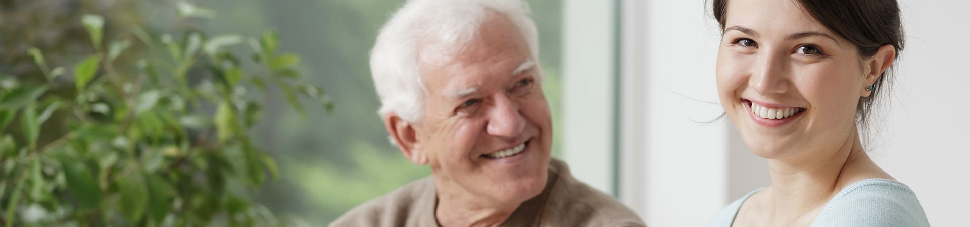 A senior man smiles at his daughter