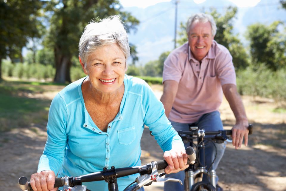 Elderly couple ride bikes together