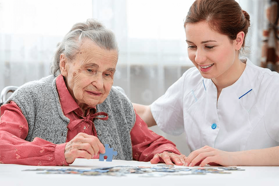 Daughter having tea and spending time with elderly father
