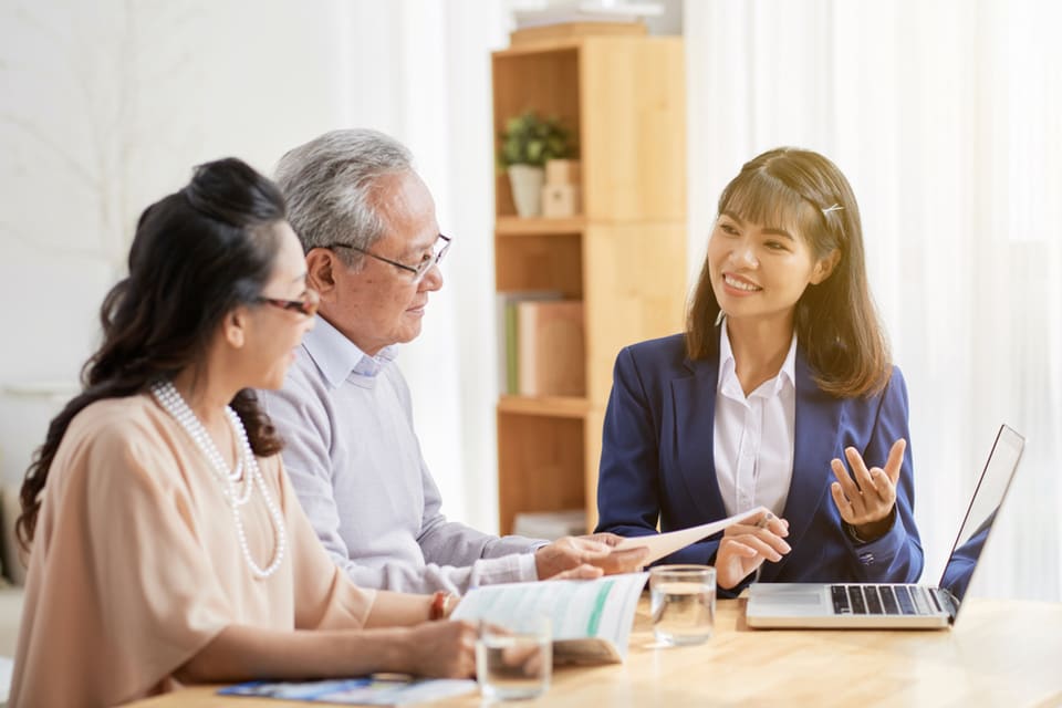 Older couple talking with younger woman about power of attorney.