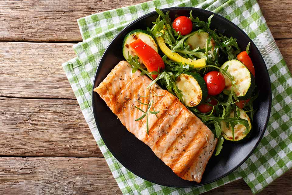 Cooked salmon and veggies on a plate