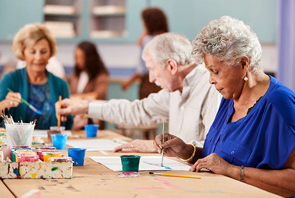 A group of seniors painting during an art class