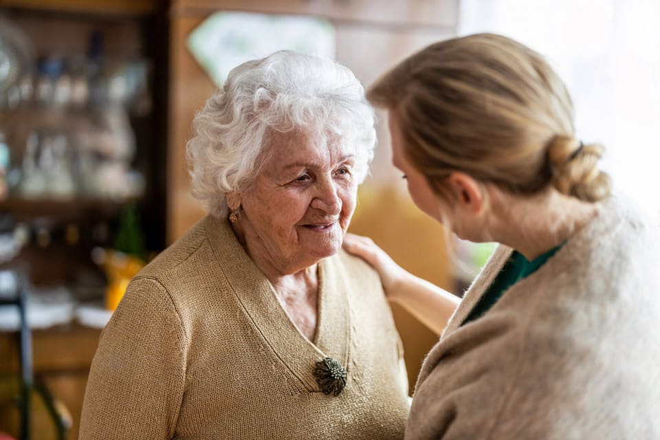 A senior woman and caregiver work to understand if her condition is dementia or a reversible condition.