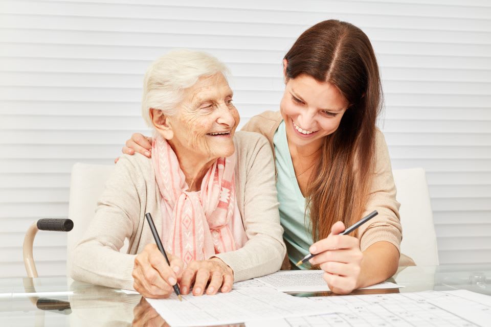 Senior and daughter reviewing memory care checklist