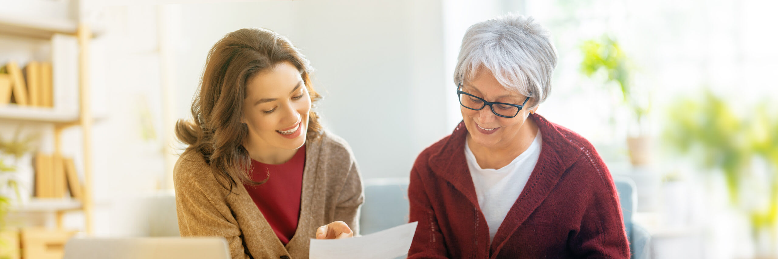 Senior looking at paperwork with daughter