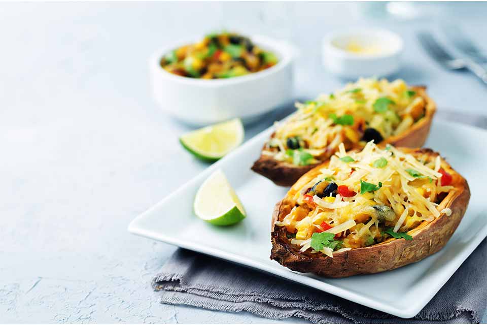 Baked sweet potatoes with cheese and a lime