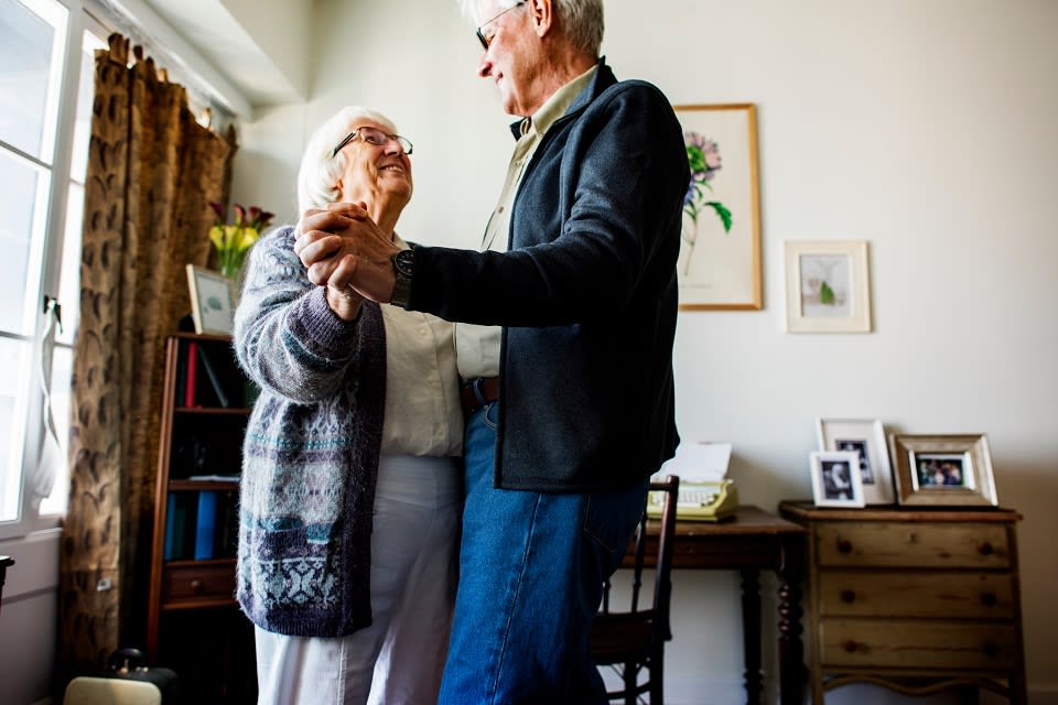 Elderly couple dancing together