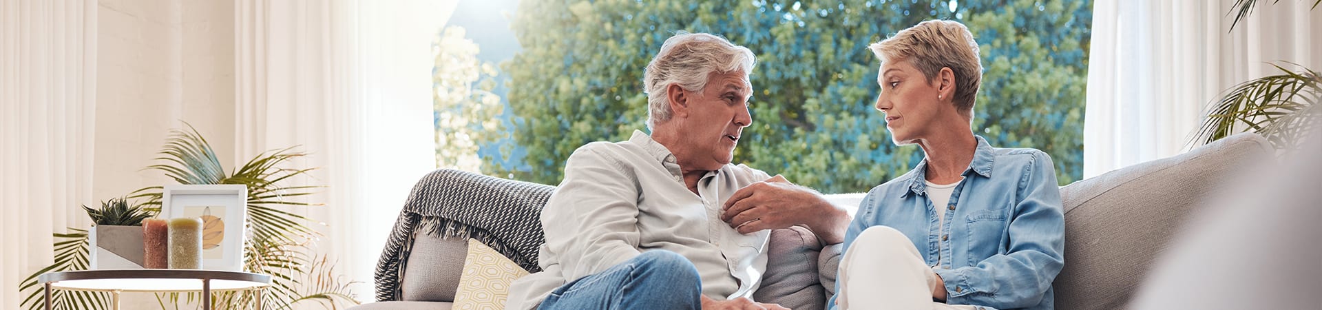 Two people talking on a couch