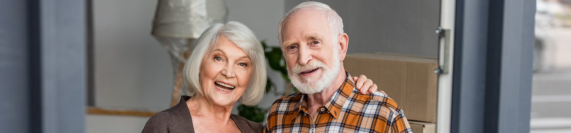 A senior couple posing together and smiling