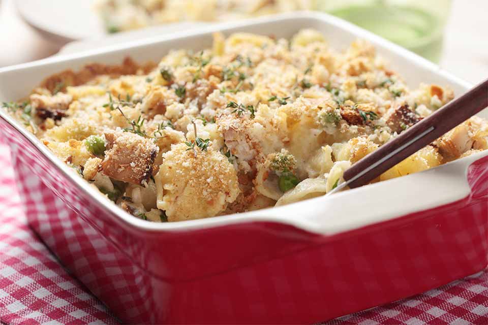 Tuna casserole with veggies in a red casserole dish