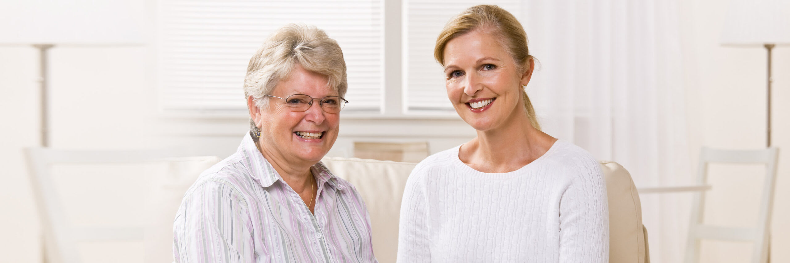 A home care worker and a senior woman smiling