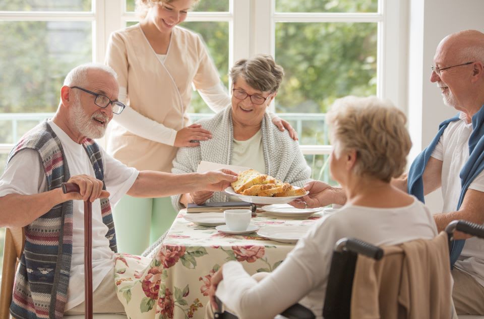 Group of happy seniors have breakfast at an assisted living facility