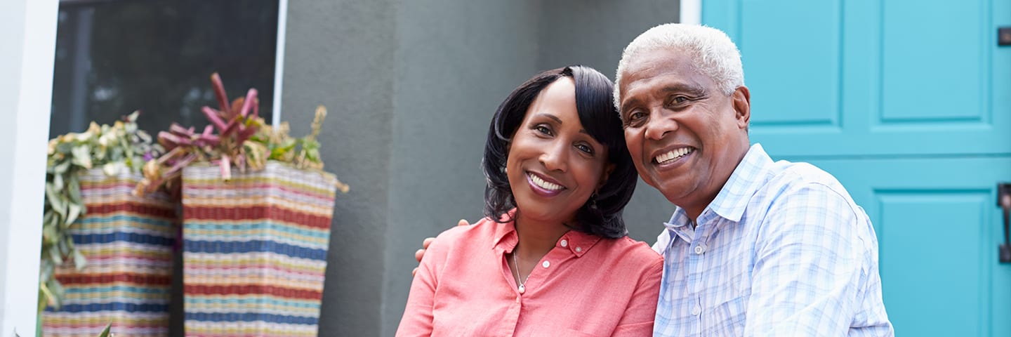 Senior and caregiver sitting on front door steps